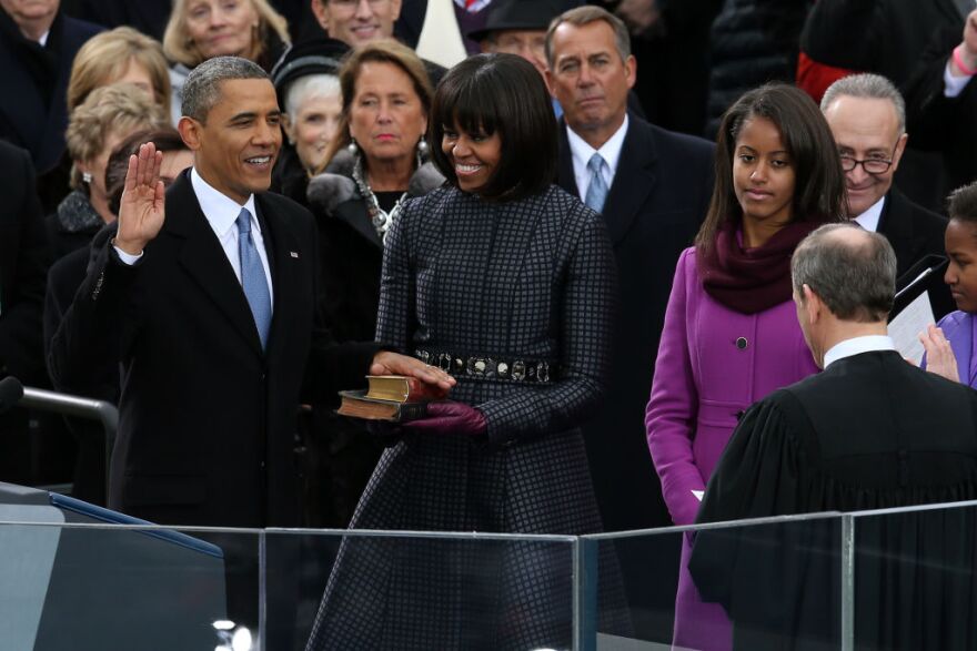 WASHINGTON, DC - JANUARY 21:  U.S. President Barack Obama (L) is sworn in during the public ceremony by Supreme Court Chief Justice John Roberts as First lady Michelle Obama, and daughters, Sasha Obama and Malia Obama look on during the presidential inauguration on the West Front of the U.S. Capitol January 21, 2013 in Washington, DC.   Barack Obama was re-elected for a second term as President of the United States.  (Photo by Alex Wong/Getty Images)