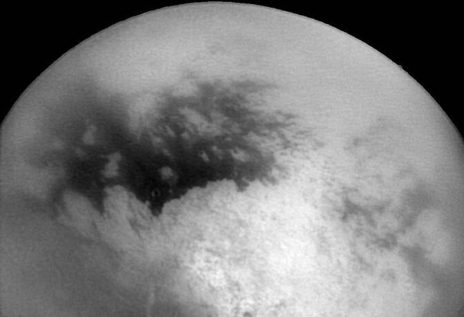 This NASA Cassini Spacecraft image released 14 December, 2004, shows Saturn's moon Titan as Cassini approached it 11 December for its second close encounter with the intriguing moon. The bright and dark regions near the center of the frame are features on Titan's surface. 