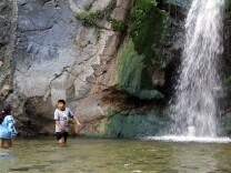 Children play under the waterfalls in Eaton Canyon Park on Wednesday afternoon, March 27.