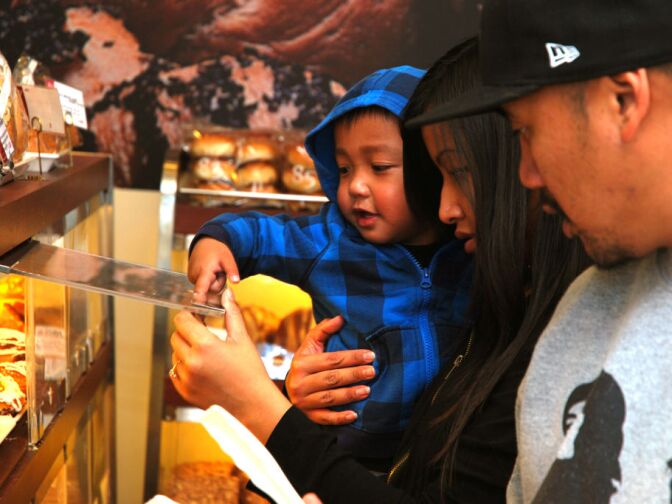 WEST COVINA, Calif. -- Jayden, age 2, helps his mother Channthy Peav of Baldwin Park select baked goods in the storefront of 85°C Bakery Cafe on Jan. 16. This company-owned West Covina location is the third to open in the United States, with more openings planned throughout Southern California. The Taiwan-based chain, while new to the U.S. market, operates more than 700 stores worldwide.