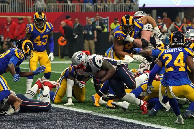 TOPSHOT - Running back for the New England Patriots Sony Michel (C) scores a touchdown during Super Bowl LIII between the New England Patriots and the Los Angeles Rams at Mercedes-Benz Stadium in Atlanta, Georgia, on February 3, 2019. (Photo by TIMOTHY A. CLARY / AFP)        (Photo credit should read TIMOTHY A. CLARY/AFP/Getty Images)