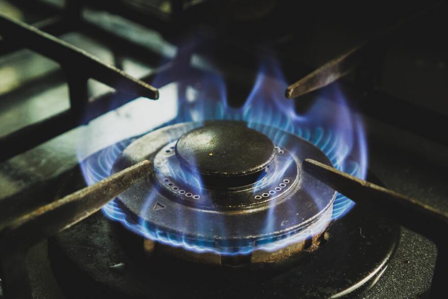 A close-up image of a lit gas stovetop.
