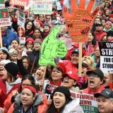 TOPSHOT - Striking teachers and their supporters rally in downtown Los Angeles, California on the second day of the teachers strike, on January 15, 2019. - Teachers of the Los Angeles Unified School District (LAUSD), the second largest public school district in the United States, are striking for smaller class size, better school funding and higher teacher pay. (Photo by Robyn Beck / AFP)        (Photo credit should read ROBYN BECK/AFP/Getty Images)