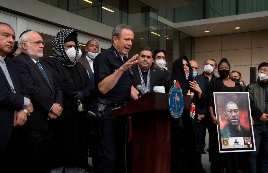 Los Angeles Police Chief Michel Moore (C) joins local faith leaders in a vigil for George Floyd at police headquarters in Los Angeles, California on June 5, 2020. - Protesters gathered in solidarity with victims of alleged state violence inside and outside of LA County's jail system, one of the largest in the world. Organized by members of the Justice LA coalition, the "RoseFromConcrete" action was inspired from a poem by the late Tupac Shakur, as protest actions continue across America following the death of George Floyd while under police custody. Taylor, a 26-year-old African American woman, was fatally shot on March 13, 2020 by Louisville Metro Police Department officers. Breonna Taylor on what would have been her 27th birthday in Hollywood, California on June 5, 2020. (Photo by Mark RALSTON / AFP) (Photo by MARK RALSTON/AFP via Getty Images)