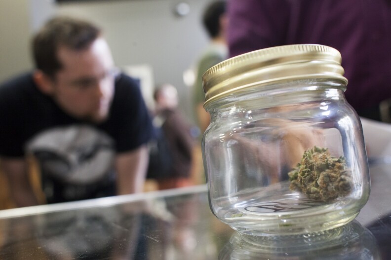 BELLINGHAM, WA - JULY 8: Customers shop for marijuana at Top Shelf Cannabis, a retail marijuana store, on July 8, 2014 in Bellingham, Washington. Top Shelf Cannabis was the first retail marijuana store to open today in Washington state, nearly a year and a half after the state's voters chose to legalize marijuana.  (Photo by David Ryder/Getty Images)