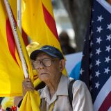 A protester holds a Vietnamese flag red flag with gold star designed in 1940 and used during an uprising against French rule in southern Vietnam, during a rally against the visit of Vietnamese Prime Minister Nguyen Xuan Phuc to the White House in Washington, DC on May 31, 2017. / AFP PHOTO / Andrew CABALLERO-REYNOLDS        (Photo credit should read ANDREW CABALLERO-REYNOLDS/AFP/Getty Images)