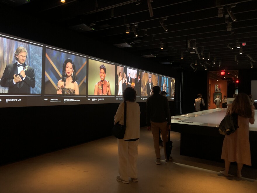 A photo of different Academy Award winners on a screen in the Academy Museum in Los Angeles.