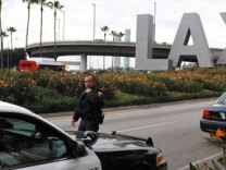 A police officer walks to his patrol car at a security checkpoint near the entrance to Los Angeles International Airport on December 26, 2009.