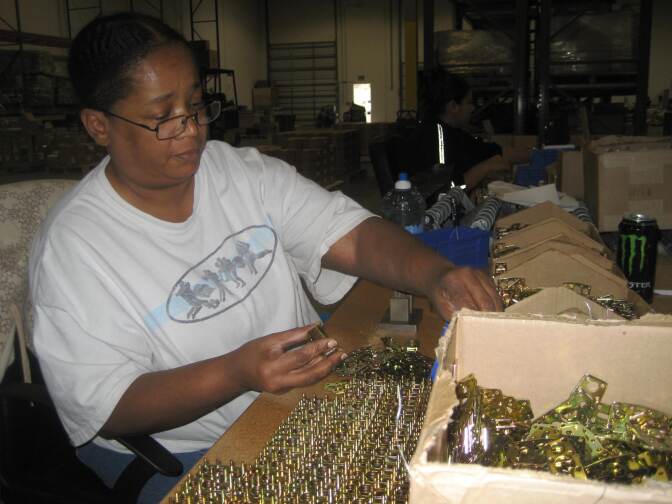LaTanya Taylor "stacking" padlock parts at Pacific Lock in Valencia