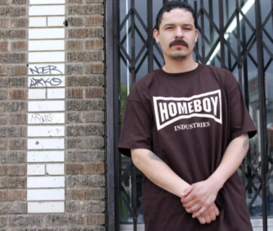 Former gang member who uses the nickname 'Jose Aleman,' 34, wears a Homeboy Industries tee shirt, while posing for a photo on a street in East Los Angeles, California, 23 March, 2005. Homeboy Industries is an organization trying to foster new lives for gang members.
