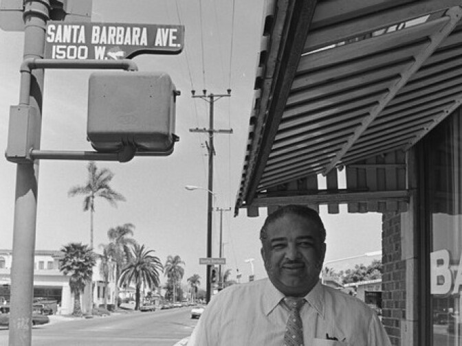 Celes King III poses in front of his bail bonds business on the corner of Denker Av and, what was then, Santa Barbara Av. He worked to rename Santa Barbara Av into Martin Luther King Blvd in 1983.