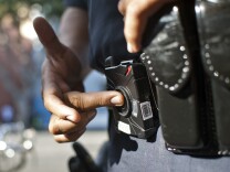 Officer Guillermo Espinoza pushes a button to turn his lapel camera on and off. The cameras don't roll for the entire shift, only when an officer presses record.