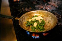 A dish made of fiddlehead ferns, duck confit and pasta is prepared by O'Malley.