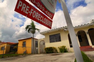 A pre-foreclosure sign is seen in front of a home in Miami, Florida.