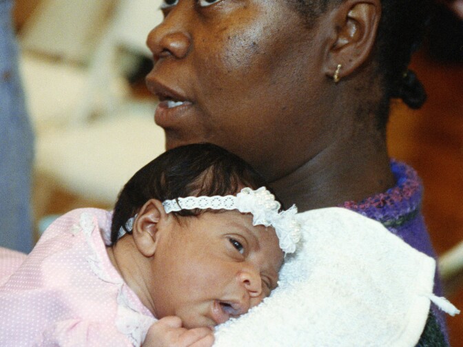 Elvira Evers holds her new-born daughter Jessica Evers-Jones, at a press conference on May 7, 1992 at St. Francis Medical Center in Los Angeles and talks about being shot in the abdomen during rioting. Elvira was in her 38th week of pregnancy when a bullet pierced her abdomen and lodged in the babys upper right forearm. (AP Photo/Olga Shalygin)