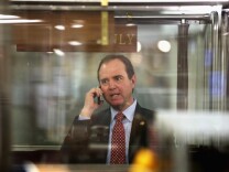 File: U.S. Rep. Adam Schiff (D-CA) talks on his phone while he is riding the House subway Jan. 28, 2015 on Capitol Hill in Washington, D.C.