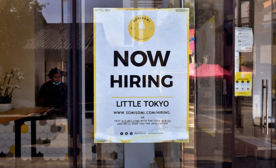 A sign on a glass door reads: "Now Hiring. Little Tokyo" with additional contact info.