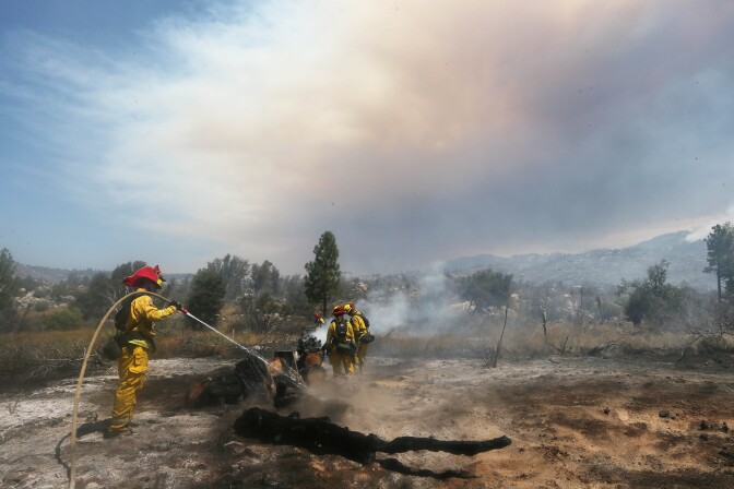 IDYLLWILD, CA - JULY 26:  Firefighters work as the Cranston Fire burns in San Bernardino National Forest on July 26, 2018 near Idyllwild, California. Fire crews are battling the 4,700-acre fire in the midst of a heat wave.  (Photo by Mario Tama/Getty Images)