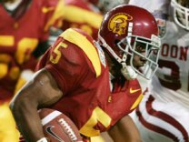 File: Running back Reggie Bush #5 of the USC Trojans carries the football against the Oklahoma Sooners defense in the second quarter during the FedEx Orange Bowl 2005 National Championship on January 4, 2005 at Pro Player Stadium in Miami, Florida.