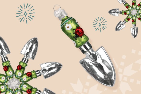 A silver trowel ornament is decorated with a lady bug on the green handle
