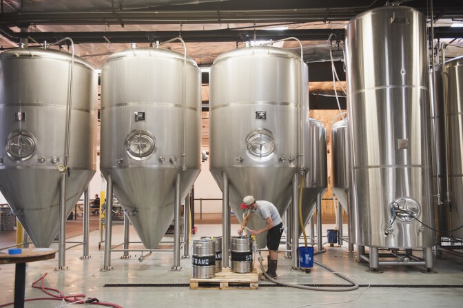 Brad Couey cleans kegs at Strand Brewery in Torrance on May 30, 2018. Strand provided the momentum that pushed Torrance to become the brewery mecca it is today. 