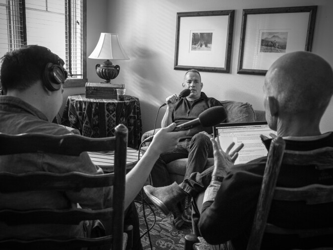 (L-R) James Kim, Tom Hanks and John Horn recording an interview for "The Frame" on KPCC at the 43rd Telluride Film Festival