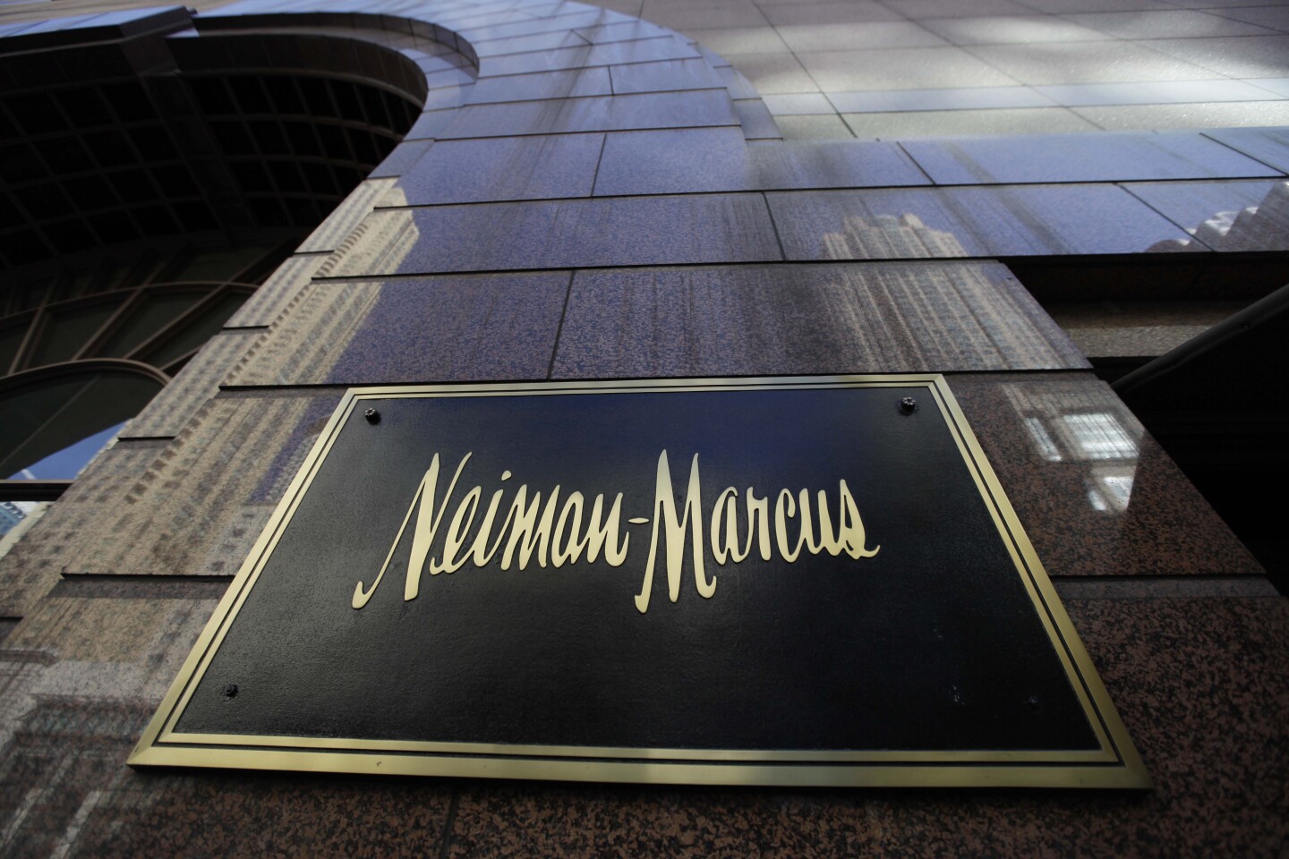 In this March 11, 2009 file photo, the Chicago skyline is reflected in the exterior of Neiman Marcus on Michigan Ave., in Chicago. Luxury retailer Neiman Marcus Inc. said Wednesday, Dec. 9, 2009, its fiscal first-quarter profit fell 34 percent as consumers continued to hold back on high-end purchases.