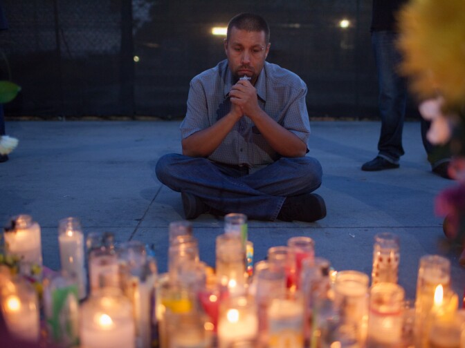 Gabriel Torres prays for his mother Margarita Gomez, who was killed by John Zawahri, outside of the Santa Monica College library on June 11th, 2013.