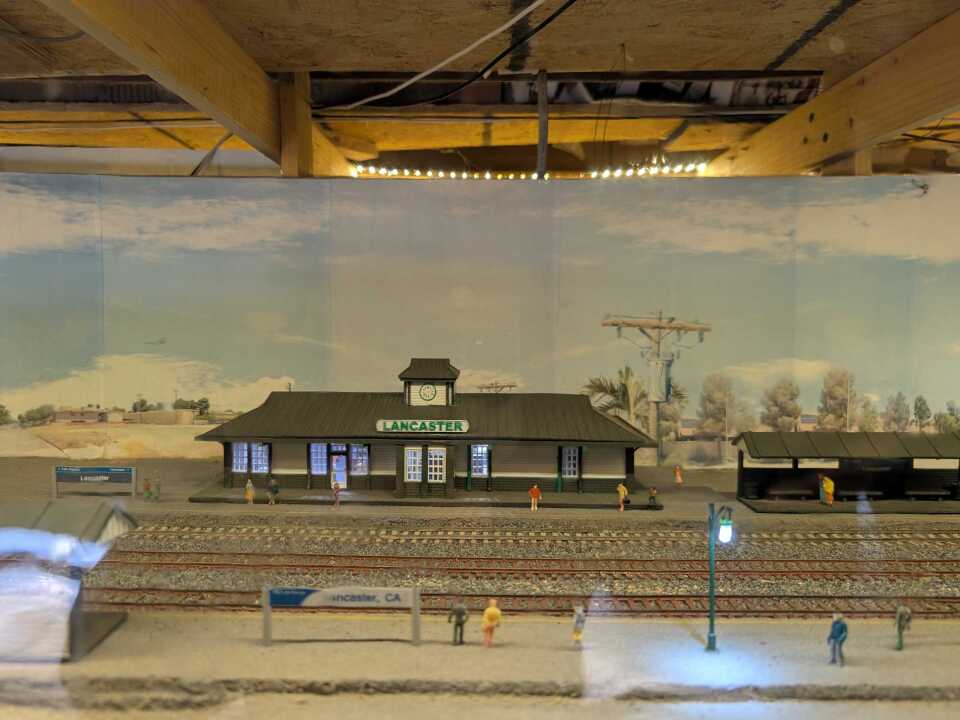 A model toy train station with the word, "Lancaster" on the roof.