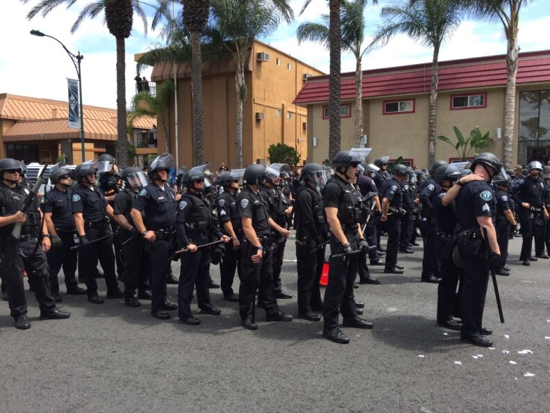 Anaheim police prepares to make arrests as they continue to push on Katella while a chopper gives the "unlawful assembly" order on Wednesday, May 25, 2016.