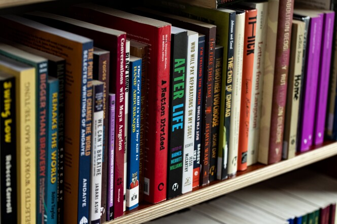 A close up of a book case full of colorful books. 