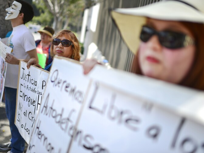 Lucy Sanchez, right, demonstrates in front of the Mexican consulate in Los Angeles Thursday. Sanchez's cousin was recently arrested by police in Michoacan State in Mexico.

Demonstrators gather in front of the Mexican consulate near McArthur Park in Los Angeles Thursday on the one-year anniversary of a massacre of farmers in Michoacan State in Mexico. 