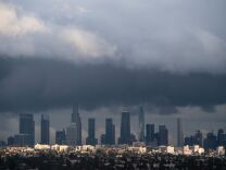 TOPSHOT - Rain clouds move over downtown Los Angeles, California on January 12, 2017.  
A series of storms that have rolled across California in the past week dumping heavy rain and snow could herald the end of a punishing historic drought, officials said. / AFP / Robyn BECK        (Photo credit should read ROBYN BECK/AFP/Getty Images)