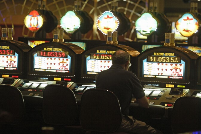 A patron plays a slots machine Friday, Oct. 22, 2004, at the SPA Resort Casino in Palm Springs, Calif. Proposition 70 would remove the 2,000-per-tribe cap on slot machines and also allow tribes to operate Las Vegas-style games currently banned in California, including roulette and craps. In return, casino-owning tribes would give the state 8.84 percent of their net income from both slot machines and table games. Though promoters predicted they would lose at the polls and ended their campaign earlier this month, the initiative will remain on the Nov. 2 ballot. (AP Photo/Damian Dovarganes)