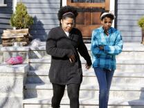 Two women leave after placing flowers on the doorstep of the Richard house in the Dorchester neighborhood of Boston, Tuesday, April 16, 2013. Martin Richard, 8, was killed in Monday's bombings at the finish line of the Boston Marathon. The boy’s mother, Denise, and 6-year-old sister, Jane, were badly injured.