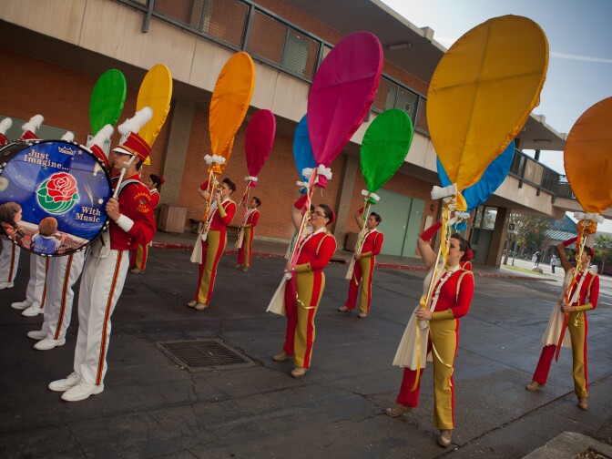 The color guard for the Tournament of Roses Honor Band warms up before their performance at Pasadena City College on Friday.