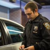 NEW YORK, NY - DECEMBER 03:  New York Police Department (NYPD) Officer Joshua Jones wears a body camera during a mock traffic stop to demonstrate how the cameras will be used during a press conference on December 3, 2014 in New York City. The NYPD is beginning a trial exploring the use of body cameras; starting Friday NYPD officers in three different precincts will begin wearing body cameras during their patrols.  (Photo by Andrew Burton/Getty Images)