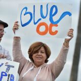 Supporters of Democratic Congressional candidate for California's 48th District Harley Rouda, hold signs and cheer at a get-out-the-vote rally in Laguna Beach, California on election day November 6, 2018. - Rouda is running to unseat longtime incumbent Rep. Dana Rohrabacher, (R-Huntington Beach) in one of the pivotal battles in Orange County, the outcome of which will help determine if Democrats regain control of the House of Representatives. Americans started voting Tuesday in critical midterm elections that mark the first major voter test of US President Donald Trump's controversial presidency, with control of Congress at stake. (Photo by Robyn Beck / AFP)        (Photo credit should read ROBYN BECK/AFP/Getty Images)