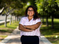 Pasadena City College student Johanna Cabrera stands for a portrait on a campus tree-lined walkway.