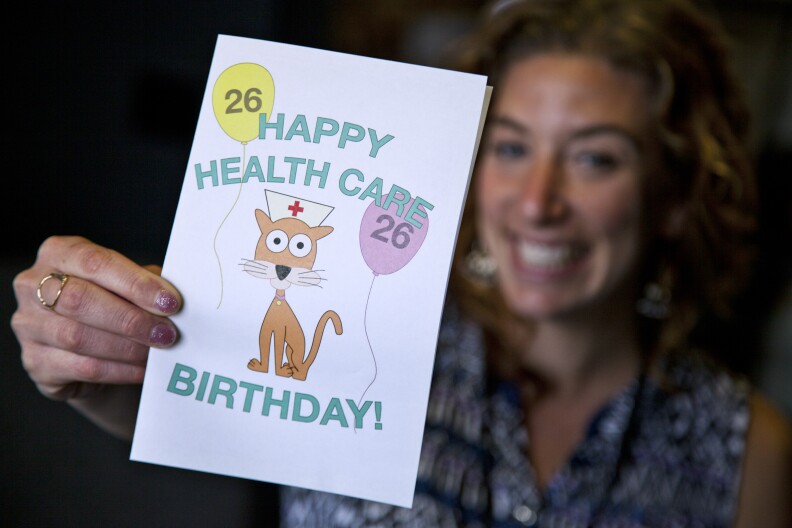 KPCC's Rebecca Plevin holds our downloadable, printable birthday card for your friends and family who are turning 26.