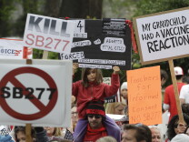 FILE - In this April 8, 2015 file photo, protesters rally against a measure requiring California schoolchildren to get vaccinated at the Capitol in Sacramento, Calif. Senate Bill 277, a California bill that would sharply limit vaccination waivers after a Disneyland measles outbreak, has generated such an acidic debate that Sen. Richard Pan, the proposal's author, was under added security this week. 