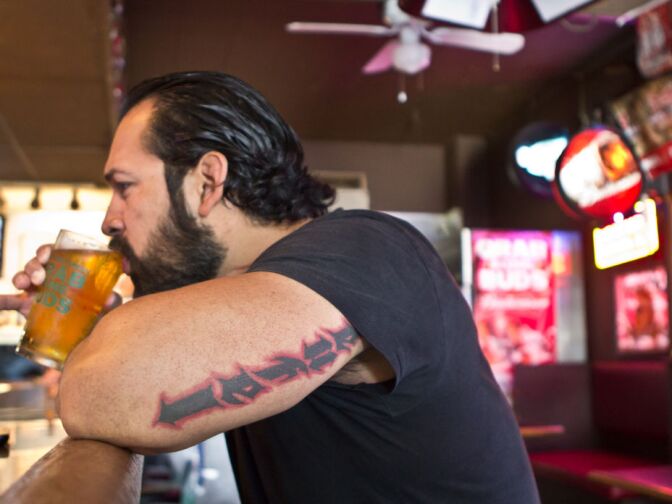 Rick Martinez drinks a sip from his beer at the King Eddy Saloon in Downtown Los Angeles.