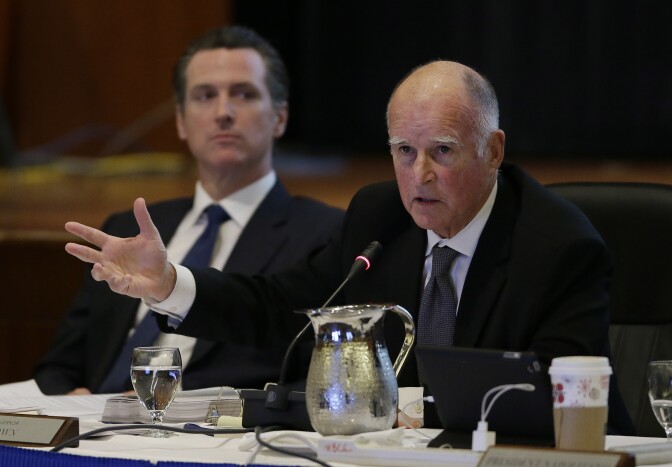 California Gov. Jerry Brown, right, gestures while speaking out against tuition increases as Lt. Gov. Gavin Newsom, left, listens during a meeting of the University of California Board of Regents Wednesday, Nov. 19, 2014, in San Francisco. A committee of the Regents approved University of California President Janet Napolitano's proposal to raise tuition as much as 5 percent annually. (AP Photo/Eric Risberg)