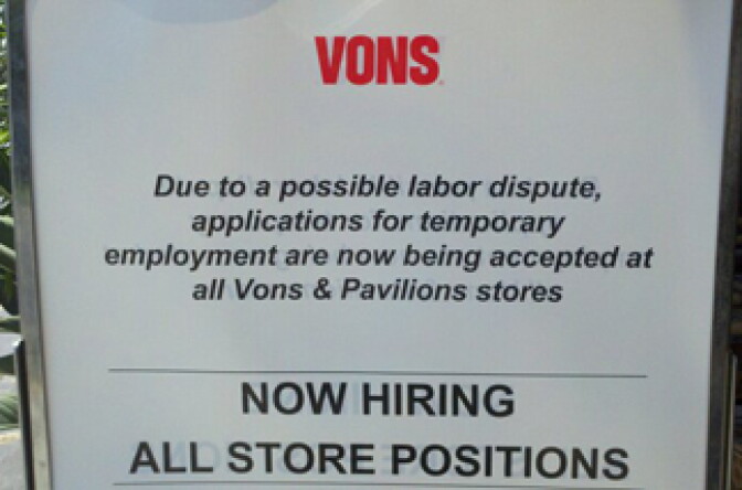 A sign outside of a Vons supermarket calls for applications for temporary employment. 