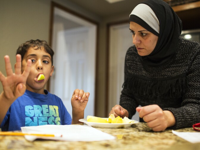Samira Elzayat helps her 6-year-old son Rami Messelmani with his math homework in their Upland home on Tuesday afternoon, Dec. 15, 2015.