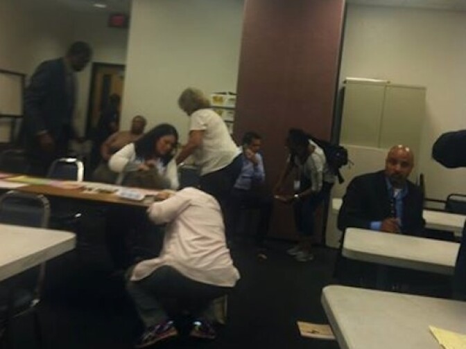 Members of the Olympic Park Neighborhood Council were attending a meeting at the LAPD West Traffic Division Station when a shooting took place in the lobby on April 7, 2014. The group members can be seen getting off the floor after taking shelter underneath desks during the shooting in a separate room. None of them were hurt.