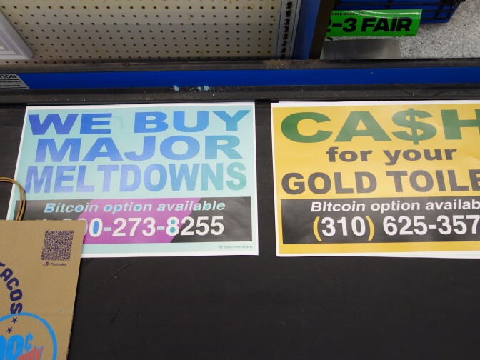 Signs on a supermarket checkout conveyor belt that read "Ca$h for your gold toilet" and "We buy major meltdowns."