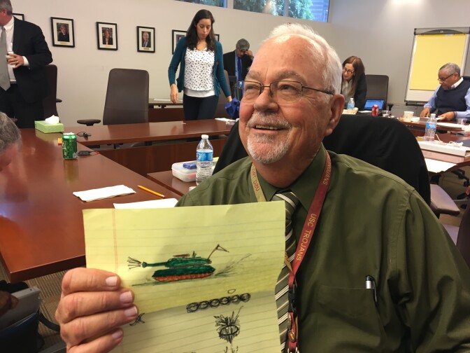 L.A. Unified School Board member Richard Vladovic holds up a doodle of a tank he drew during Tuesday's meeting. He drew it out of frustration during a discussion session about the board's vision, which he found repetitive. "I’m tired of talking," Vladovic said, calling for more bold action rather than planning.