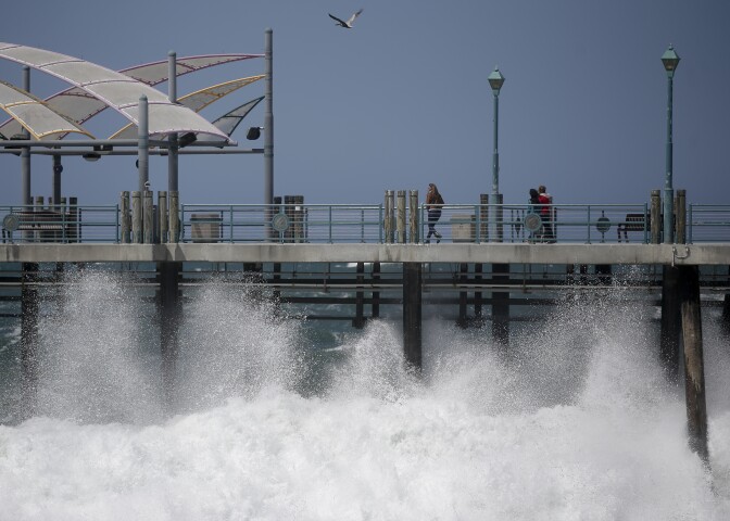 Waves hit the Redondo Beach Pier in Redondo Beach, Calif., Monday, April 8, 2013. Strong winds have begun raking parts of Southern California. The National Weather Service says the gusty northwest-to-north winds will become widespread across the region Monday and continue into the night.