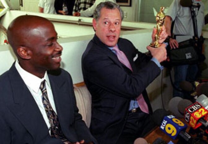 Los Angeles-based lawyer Stephen Yagman (R) displays an Oscar statuette during a press conference to publicize his client Anthony Hart's (L) federal civil rights action against LAPD chief Bernard Parks, head of the Acadamy of Motion Picture Arts and Sciences Robert Rehme, and Roadway Express, 06 April, 2000 in Venice, CA. 